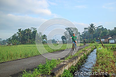 Two boys exercising on a small bicycle Editorial Stock Photo